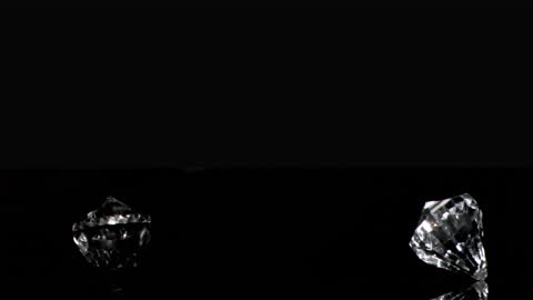 Spinning Diamonds Against a Black Background in Slow Motion