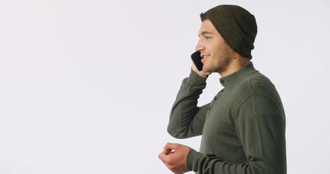 Man in Beanie Speaking on Smartphone with Copy Space - Download Free Stock Images Pikwizard.com