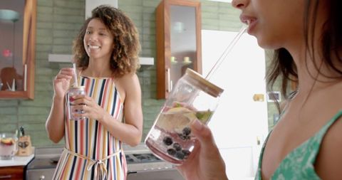 Friends Enjoy Refreshing Drinks in Modern Kitchen Setting