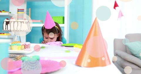 Lonely child wearing party hat in colorful celebration room