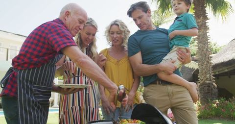 Happy Family Gathering for Outdoor Barbecue in Sunny Garden