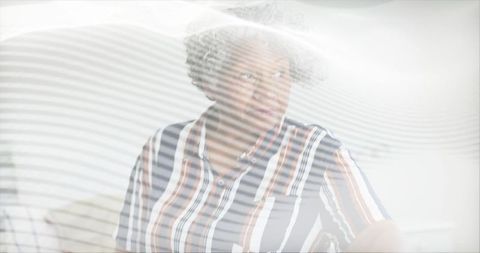 Elegant Senior Woman Relaxing at Home in Striped Shirt