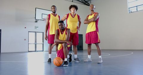 Confident basketball team displaying teamwork in gym