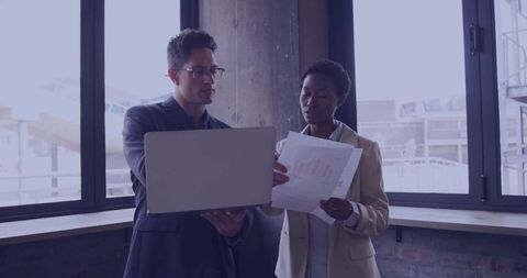 Corporate Team Analyzing Data in Modern Office Environment