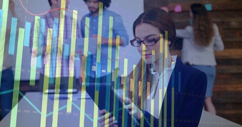 Businesswoman analyzing financial charts on tablet in collaborative coworking office