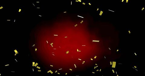 Gold confetti falling on vibrant red and black background