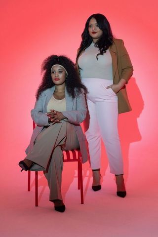 Diverse professional women posing in studio wearing blazers and black pointed heels