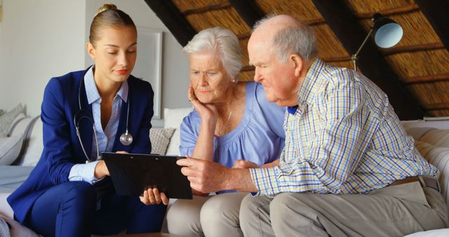 Senior Couple Receiving Health Consultation from Young Doctor in Home - Download Free Stock Images Pikwizard.com