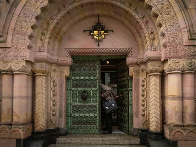 Person Entering Ornate Historic Building Through Green Door - Download Free Stock Photos Pikwizard.com