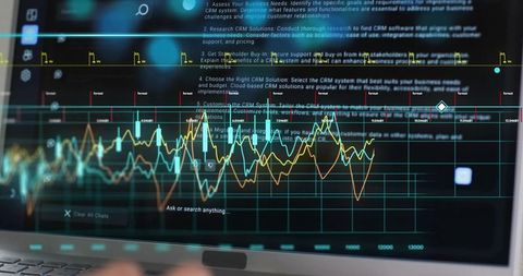 Displaying dark analytics dashboard on laptop with colorful line charts and data visualization