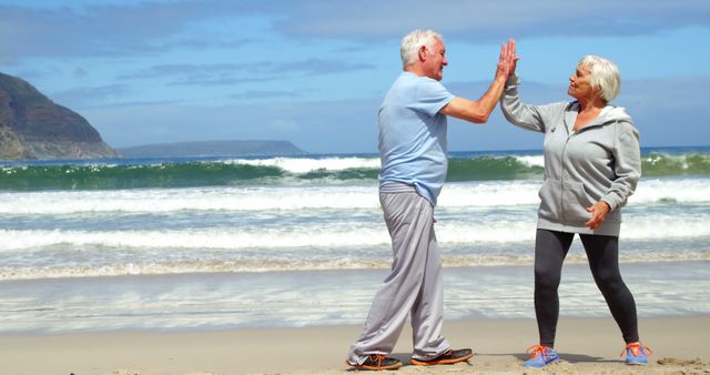 Senior Couple High-Fiving on Beach - Download Free Stock Images Pikwizard.com