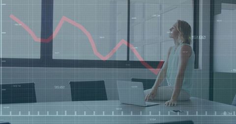 Executive Reflecting on Business Decline Graph in Modern Office