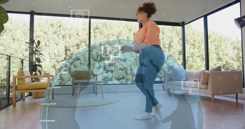 Woman interacting with holographic globe in modern living room for virtual fitness and tech