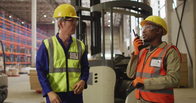 Warehouse Workers Communicating in Industrial Facility - Download Free Stock Images Pikwizard.com