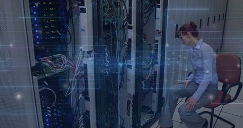 Female Technician Configuring Server Setup in Modern Data Center Facility