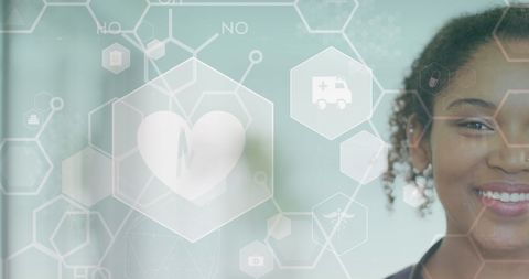 Smiling doctor with medical icons overlay, technology in healthcare