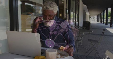 Businessman engaging with futuristic technology at outdoor cafe