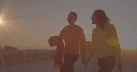 Romantic Sunset Walk Along Seaside Holding Hands
