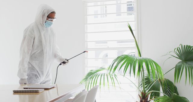 Professional Cleaner Disinfecting Office Space in Protective Gear - Download Free Stock Images Pikwizard.com