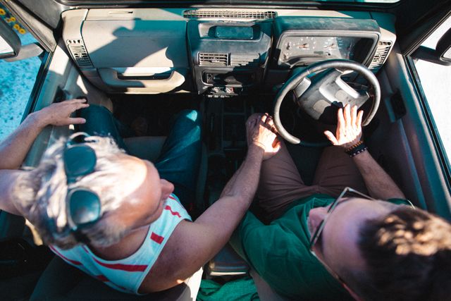 High angle view of male friends in off-road vehicle during summer road trip. summer road trip, friendship, vacation and leisure.