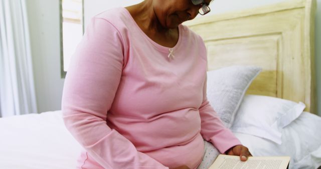 Woman in Pink Sweater Reading Book in Bedroom - Download Free Stock Images Pikwizard.com