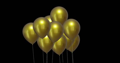 Celebratory gold balloons against dark background