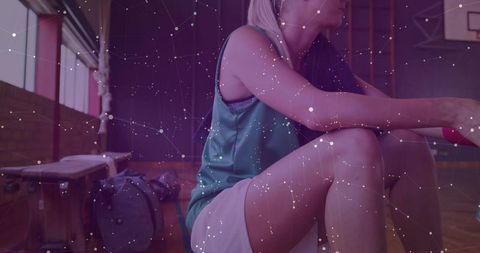 Athlete Resting in Gym Holding Basketball with Nebula Effect