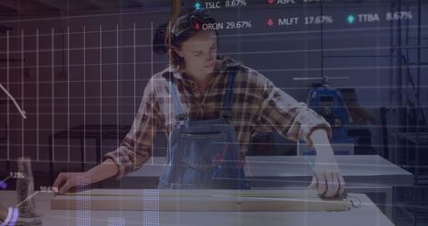 Woman Working in Workshop with Financial Data Overlay