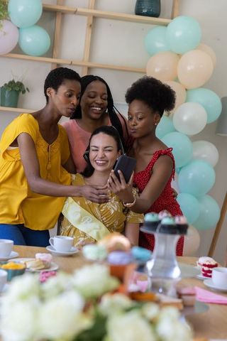 Diverse Women Celebrating with Selfie at Home Party