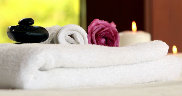 Fresh towels with black stones at luxury spa