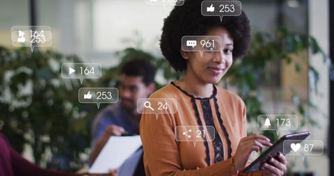 Businesswoman engaging with social media notifications in office