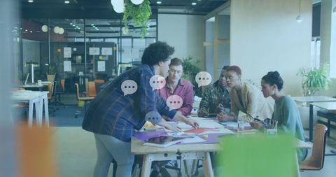 Diverse Team Collaborating in Modern Office with Message Icons