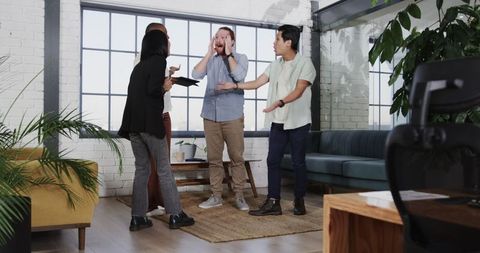 Diverse Team Celebrating Achievement with Group Hug in Office