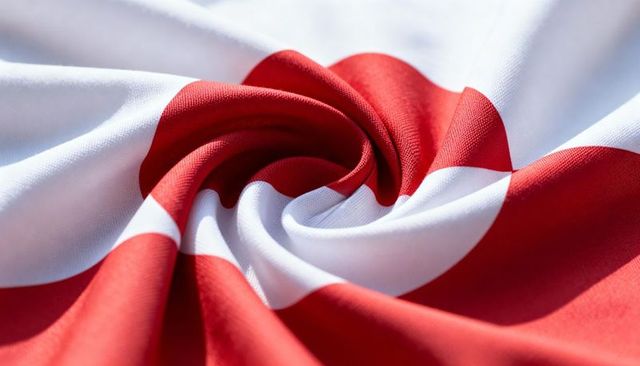 Twisted red white woven fabric creating spiral folds macro textile texture background