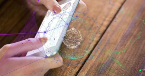Hands holding smartphone projecting holographic network navigation wireframe on wooden table