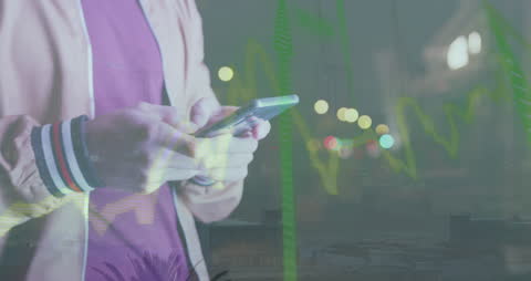 Young Professional Analyzing Financial Data on Smartphone at Night