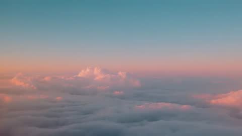Serene Morning Clouds Shifting Hues During Dawn from Above