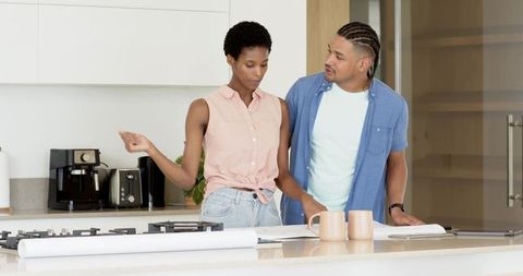 Couple Discussing House Plans at Kitchen Island