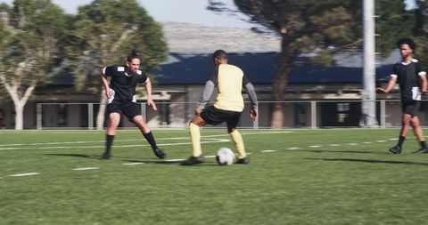 Soccer Players Discussing Strategy During Practice Outdoors