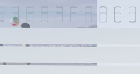 Family enjoying beach day with multicolored beach ball