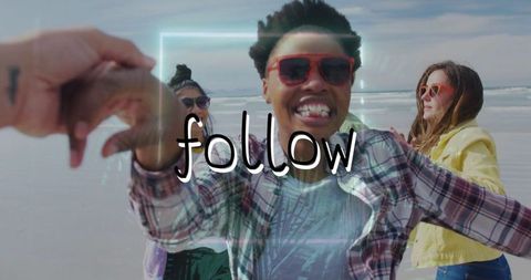 Friends Enjoying Beach Day Capturing Selfies Under Blue Sky