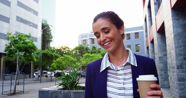 Smiling Businesswoman Holding Coffee Cup on City Street - Download Free Stock Images Pikwizard.com