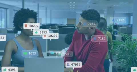 Coworkers collaborating over laptop with social media analytics and notification overlays