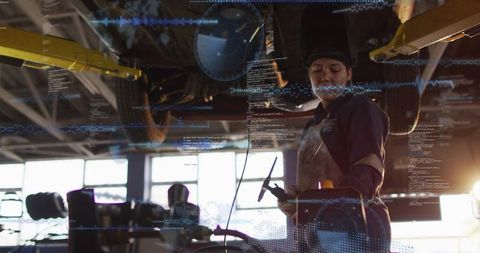 Female mechanic performing diagnostic scan beneath raised car with digital data overlays