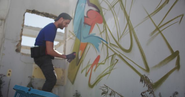 Urban Artist Creating Colorful Graffiti Mural on Abandoned Building - Download Free Stock Images Pikwizard.com