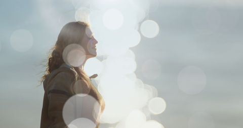 Pensive woman surrounded by dreamy glowing light