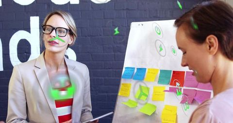 Creative collaboration in modern office with neon overlays