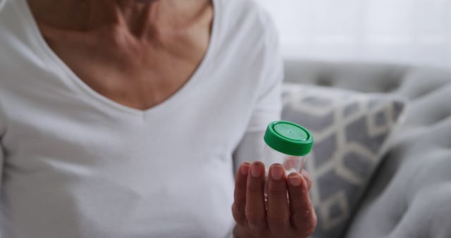 Senior Holding Medical Sample Container in Living Room - Download Free Stock Images Pikwizard.com