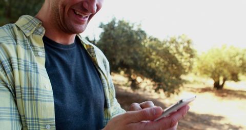 Smiling Farmer Taking Selfie in Olive Grove