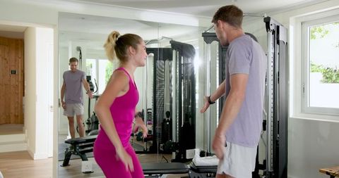 Couple exercising together in modern home gym for fitness and motivation